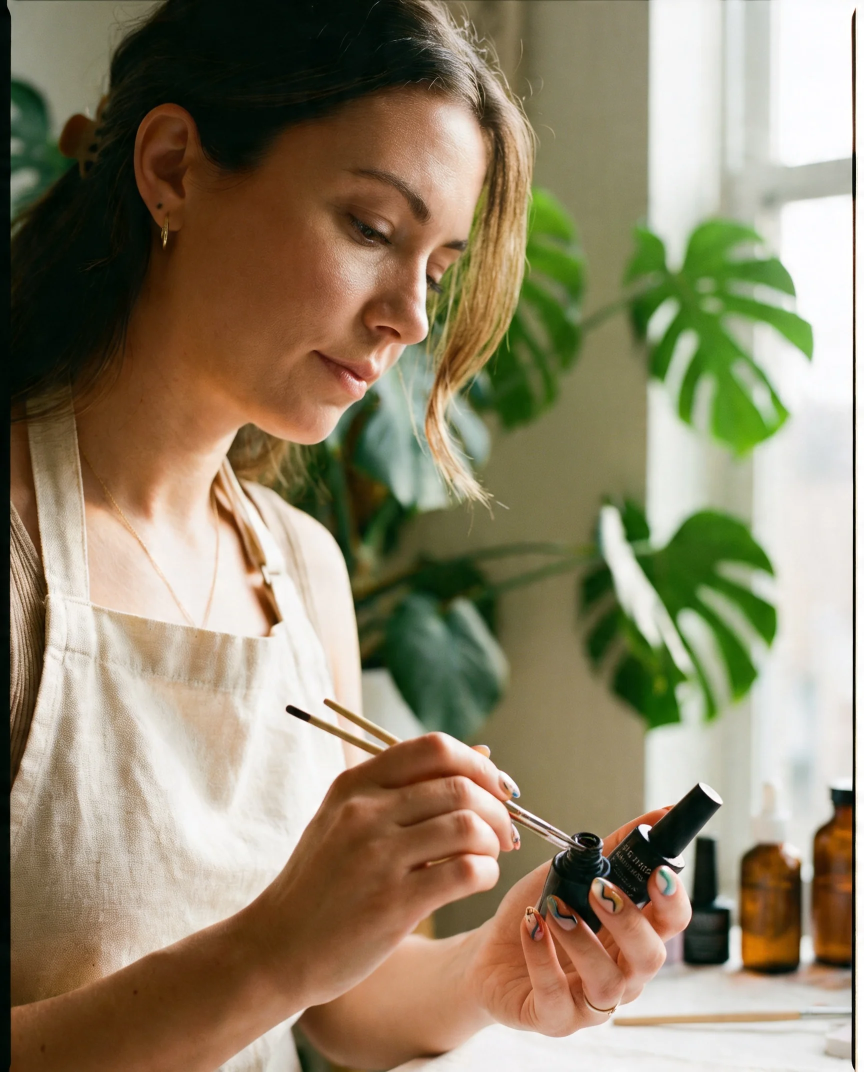 Salon owner standing behind the reception counter, lit by warm candlelight with monstera leaves in the background